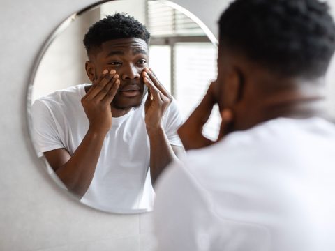 sleepy-black-man-touching-black-circles-under-eyes-2023-11-27-05-22-41-utc